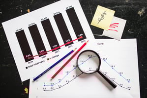 Wellness practitioner reviewing billing codes on a clipboard, with therapy equipment in the background.